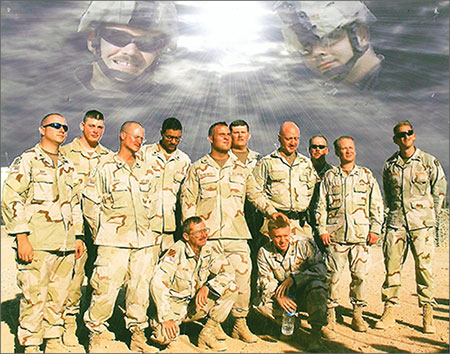 Group photo of soldiers in military uniforms with digitally enhanced cloud above their heads of image of Joey Hunt